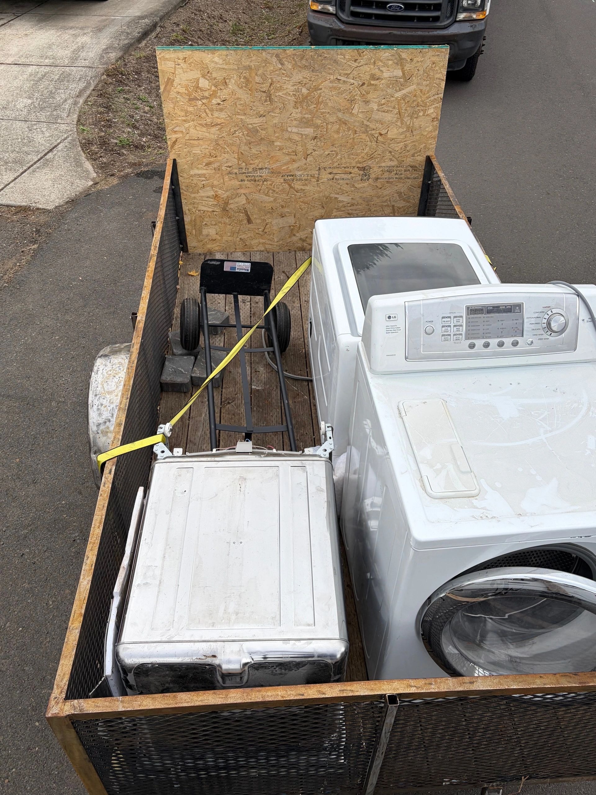 Utility trailer loaded with appliances ready for hauling