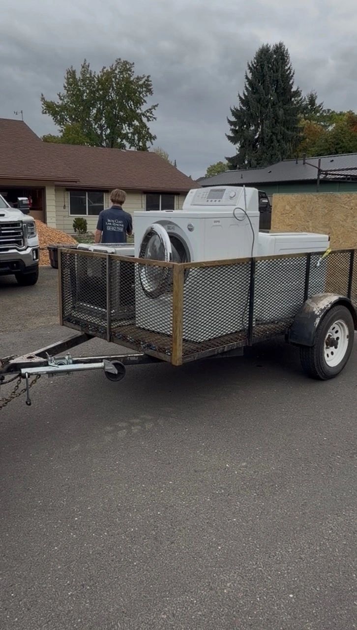 Mesh trailer parked in residential driveway for junk pickup